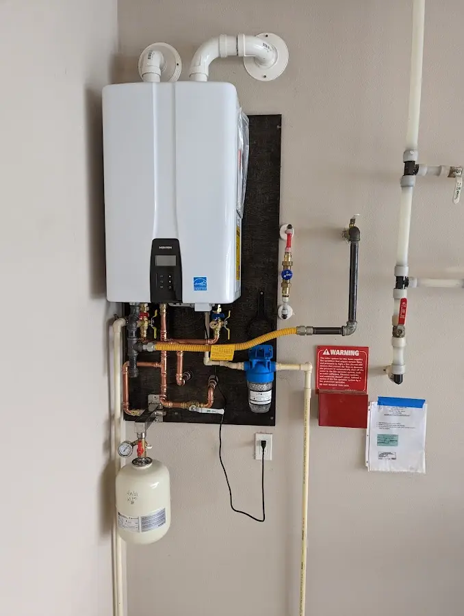 Professional plumber installing copper piping in a Gridley home